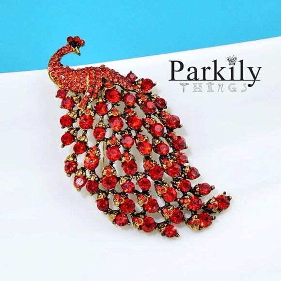 Brooch peacock in sparkly red crystals in a gold and black pin setting - Picture 1 of 2